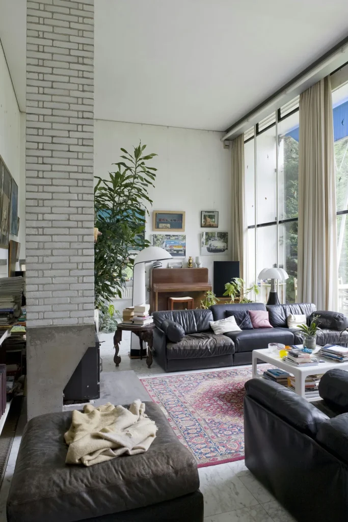 Moderne woonkamer Rotterdam met leren banken en hoge ramen — typische inboedel die verzekerd kan worden