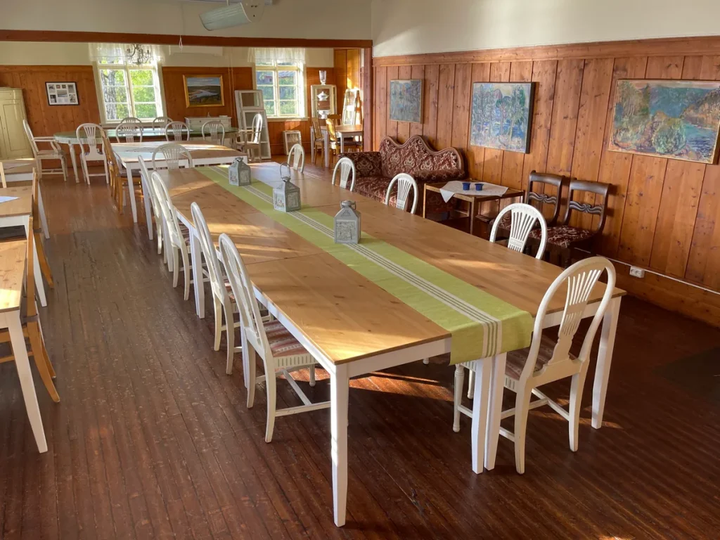 Interieur van een bed and breakfast eetzaal met houten meubels en gedekte tafels