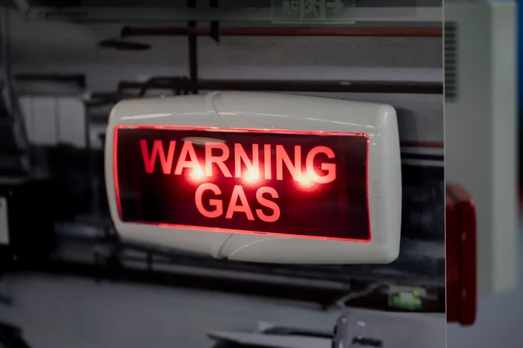 Waarschuwingsbord gasalarm in industriële werkomgeving — veiligheid op de werkvloer en werkongeval preventie